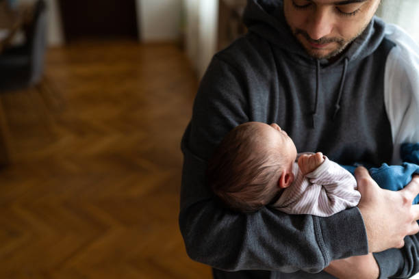 istock Father holding newborn son 1133595767