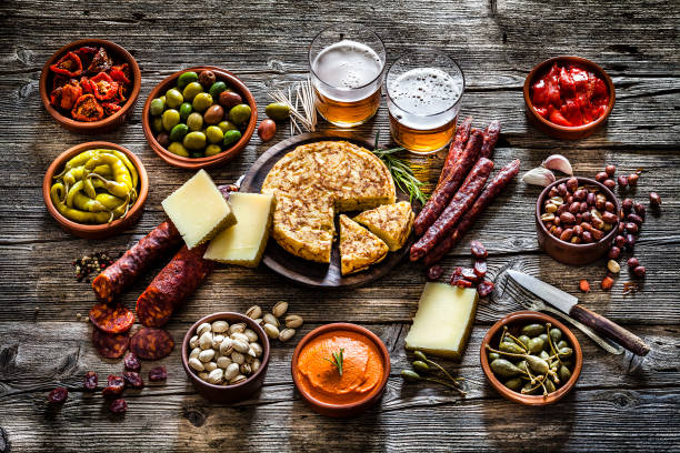 istock Tapas and beer: typical spanish food shot on rustic wooden table 1133595883