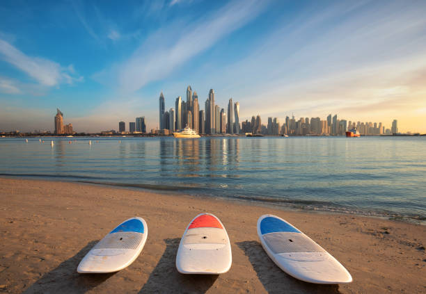 Dubai Marina Skyline with 3 surfboards on the beach in front