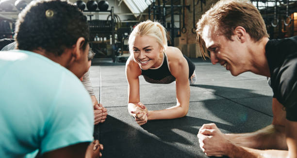 istock Gym friends smiling and planking together during a workout class 1133598680