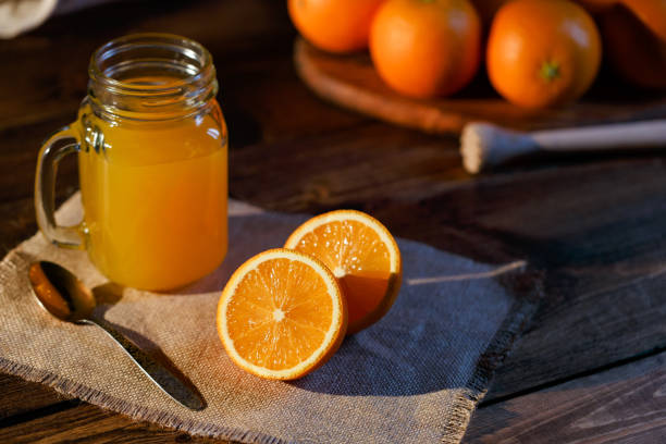 istock Orange juice glass jar shot on rustic wooden table 1133599368