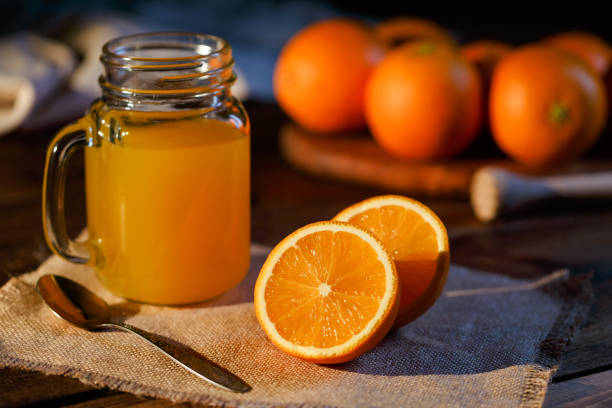 istock Orange juice glass jar shot on rustic wooden table 1133599403