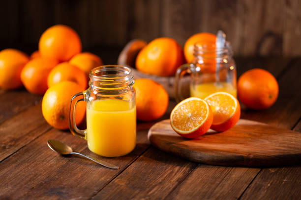 istock Orange juice glass jar shot on rustic wooden table 1133599407