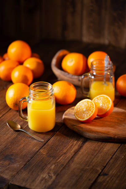 istock Orange juice glass jar shot on rustic wooden table 1133599442