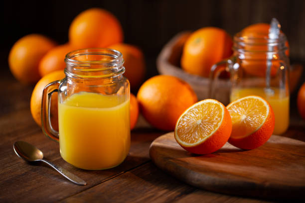istock Orange juice glass jar shot on rustic wooden table 1133599445