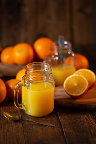 istock Orange juice glass jar shot on rustic wooden table 1133599463