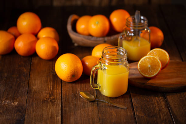 istock Orange juice glass jar shot on rustic wooden table 1133599481