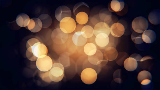 Abstract isolated blurred festive yellow and orange Christmas lights with bokeh Abstract isolated blurred festive yellow orange lights with bokeh. Sparkling circular stars motion 3D illustration. Holiday concept backdrop with twinkling bright shapes.Blinking Christmas Tree lights light through trees stock pictures, royalty-free photos & images