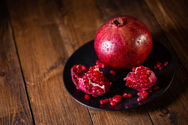Pomegranate fruit on wooden vintage background