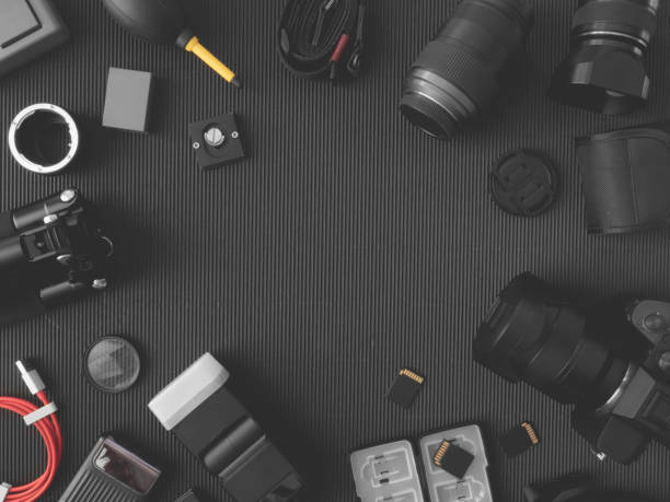 istock top view of work space photographer with digital camera, flash, cleaning kit, memory card, external harddisk, USB card reader, laptop and camera accessory on black table background 1133603845