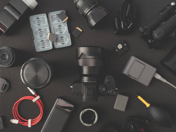 istock top view of work space photographer with digital camera, flash, cleaning kit, memory card, external harddisk, USB card reader, laptop and camera accessory on black table background 1133604514