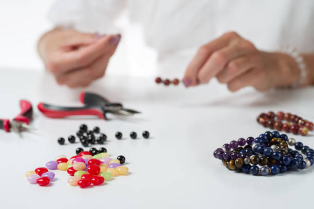 istock Jewelry making. Production bracelets and necklaces from multi-colored beads. 1133605104