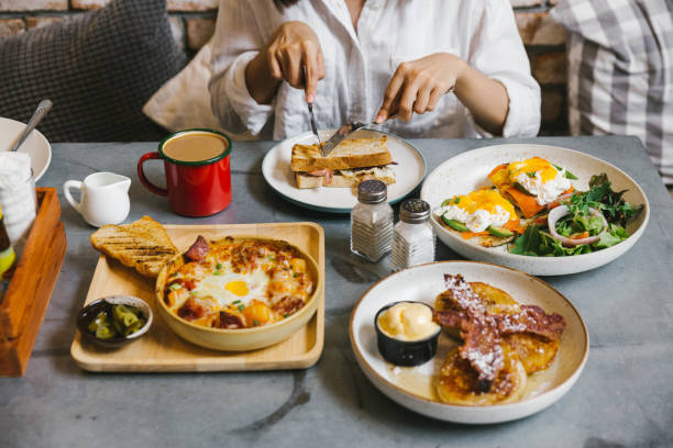 istock Eggs Benedict, Crispy Bacon stuffed French toast, Cheesy Potato with Crispy Bacon and Pancakes with Maple Syrup, Bacon and Vanilla Ice Cream. Served with Hot Latte. 1133606557