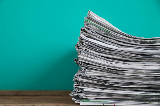 istock close up newspapers folded and stacked on the table with green background 1133606766
