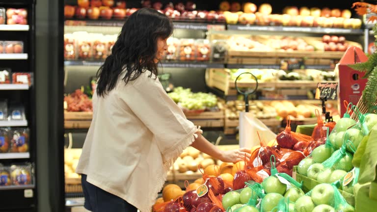 Asian Woman's hands take a vegetable in Supermarket