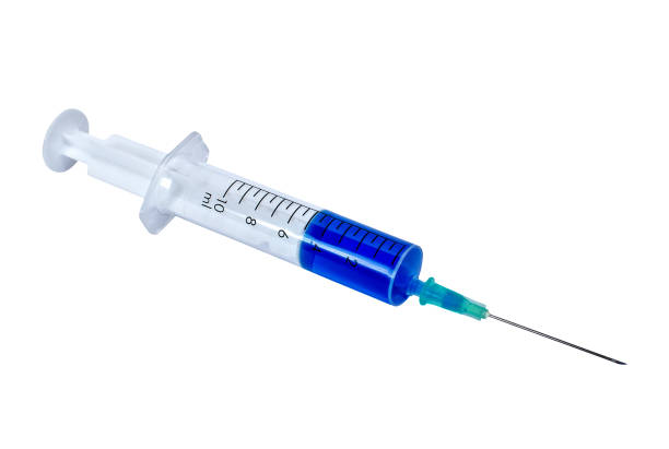 istock Syringe with blue medication isolated on a white background 1133607707