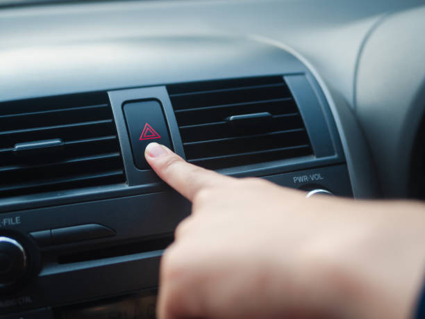 istock Driver's finger pressing car's emergency button in the car 1133609064