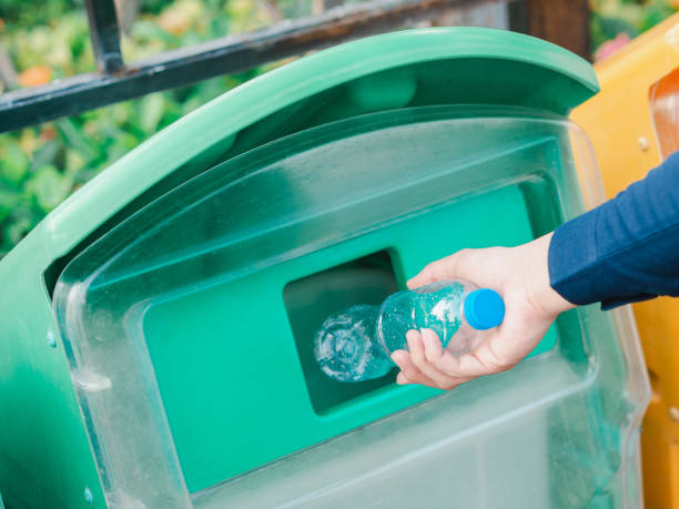 istock Closeup of man hand throwing empty plastic water bottle in recycling bin. 1133609347