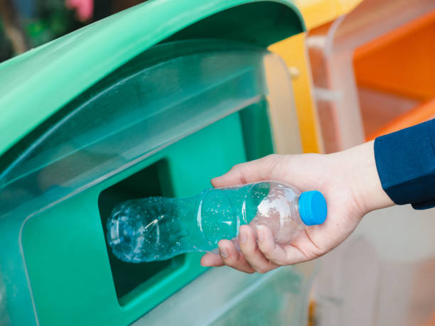 istock Closeup of man hand throwing empty plastic water bottle in recycling bin. 1133609351