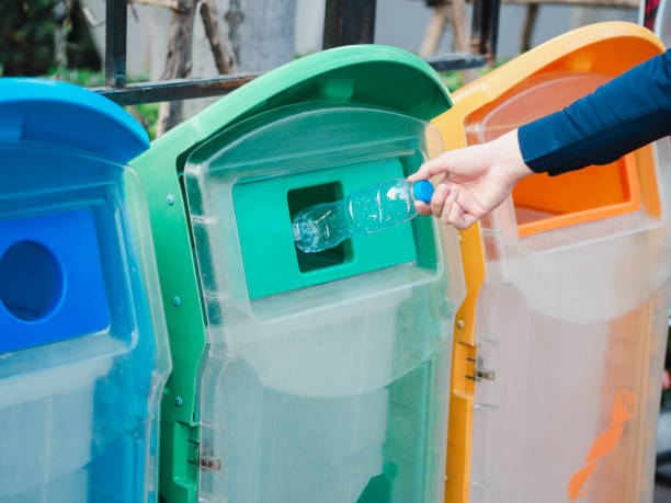 istock Closeup of man hand throwing empty plastic water bottle in recycling bin. 1133609622