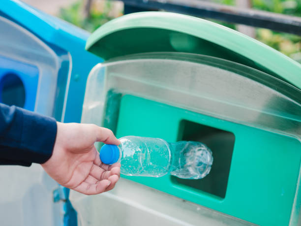 istock Closeup of man hand throwing empty plastic water bottle in recycling bin. 1133609631