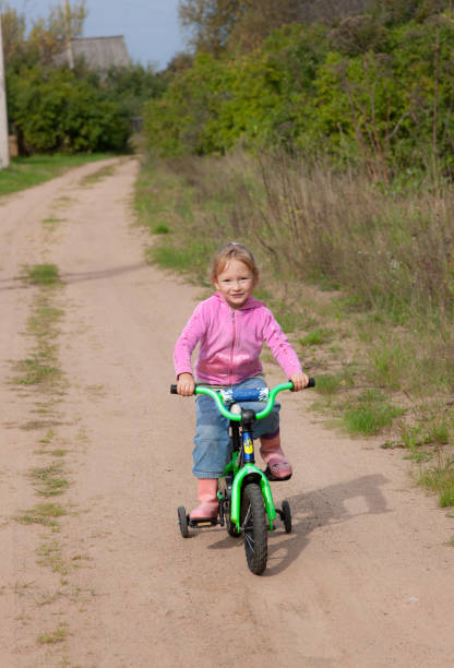 istock The little girl on a bicycle 1133609747