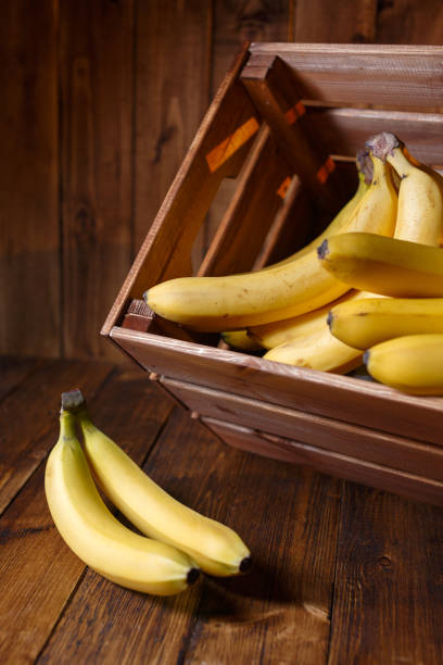 istock Bananas in a crate on rustic wood table 1133613125