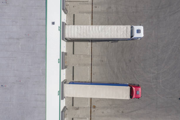 istock Trailers at docking stations of a distribution center waiting to be loaded 1133613159