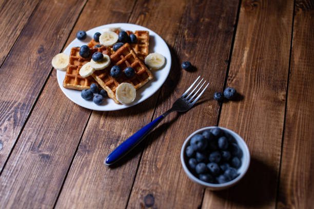 Fresh homemade belgian waffles with blueberries and banana for breakfast