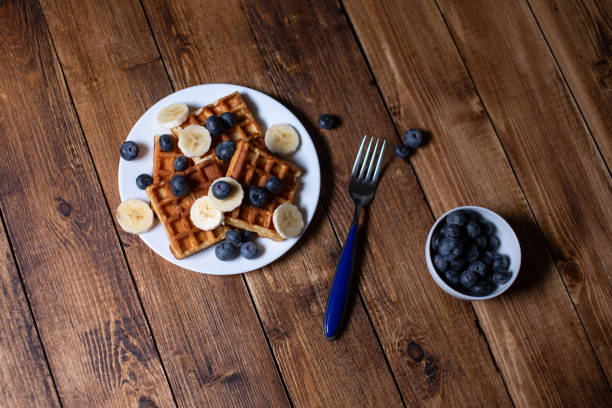 Fresh homemade belgian waffles with blueberries and banana for breakfast
