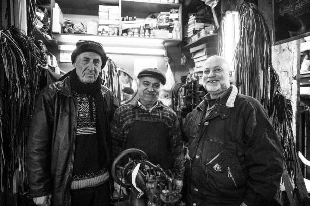 portrait of senior adult friends standing outside a store - portrait black and white senior men wisdom imagens e fotografias de stock