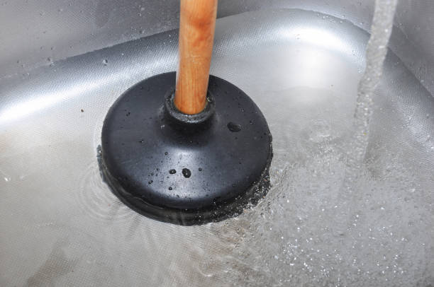 Plunger and kitchen sink. Plunger and clogged kitchen sink. Pipe cleaning concept. Sanitary engineering work. clogged drain stock pictures, royalty-free photos & images