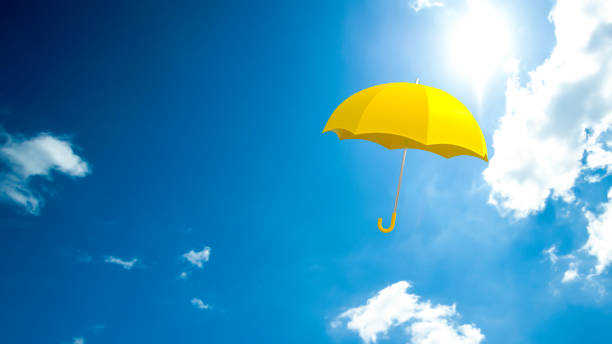 paraguas amarillo flotando en el cielo. - white mid air rain wind fotografías e imágenes de stock