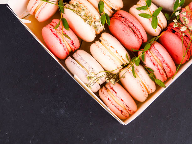 istock Colorful French or Italian macarons stack on black wood table with copy space for background. Dessert for served with afternoon tea or coffee break. 1133618911