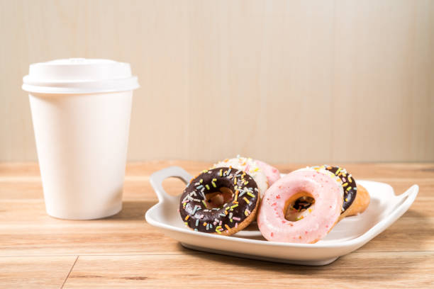 istock Donuts and coffee on wooden table. 1133620214