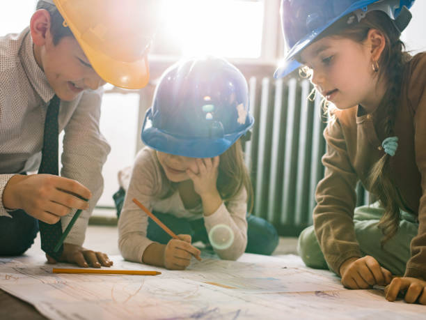 istock Team of small architects working on blueprints in the office. 1133620392