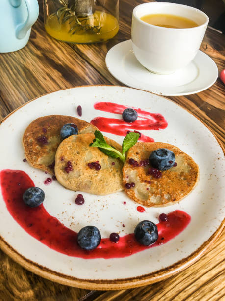 istock Pancakes with nuts and berries on a wooden table 1133621364