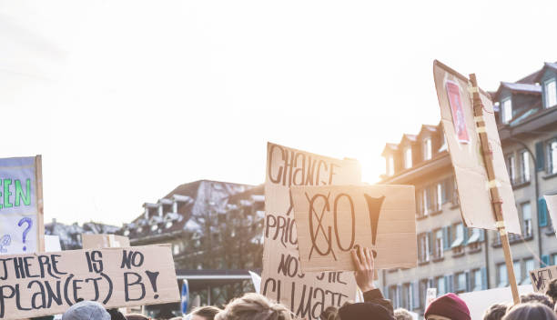 istock Group of demonstrators fight for climate change - Global warming and enviroment concept - Focus on center banners 1133621879
