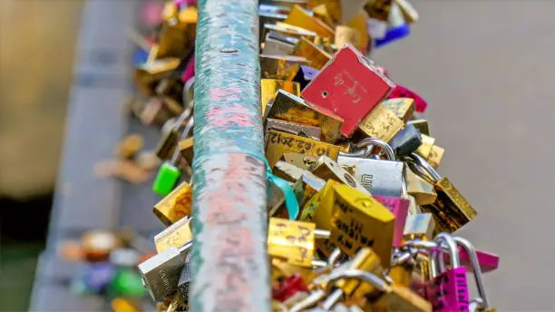 The lovelocks locked on the bridge in Paris. Couples locked their love for a lifetime in this bridge