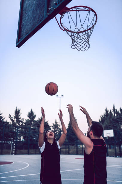istock Young Adults Having Fun Playing Basketball In The Evening 1133627582