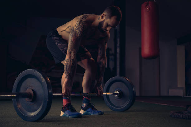 istock Male athlete start lifting weight from the floor 1133627636
