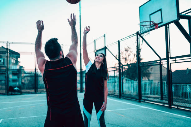 istock Athletic Couple Playing Basketball During Sunset 1133627835