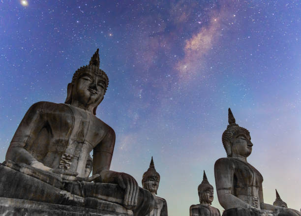 istock Milky way galaxy with buddha stature dark filter style 1133629585