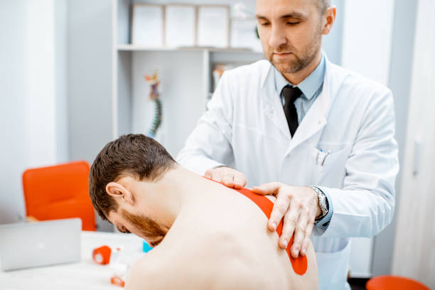 istock Therapist applying kinesio tape on a man's neck 1133630526