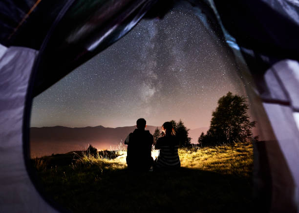 istock Couple tourists resting at night camping under stars 1133634183