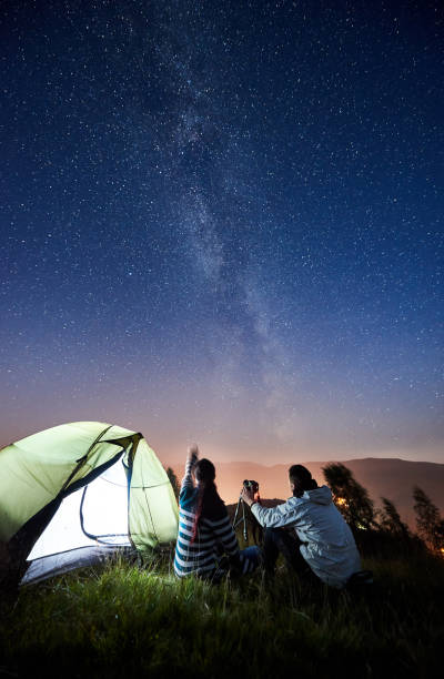 istock Couple tourists resting at night camping under stars 1133634189