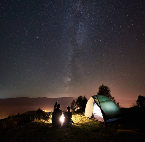 istock Couple tourists resting at night camping under stars 1133634196