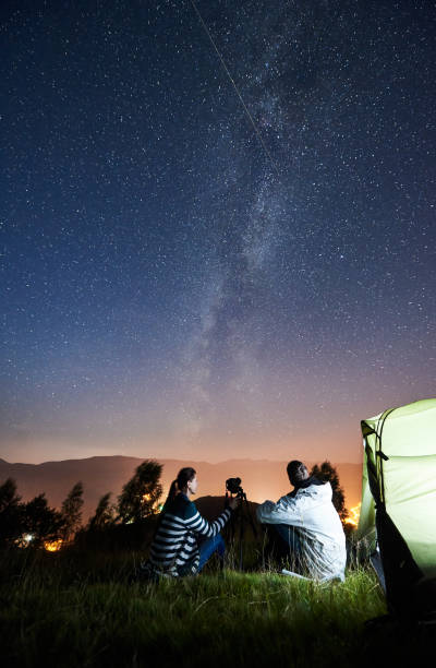 istock Couple tourists resting at night camping under stars 1133634198