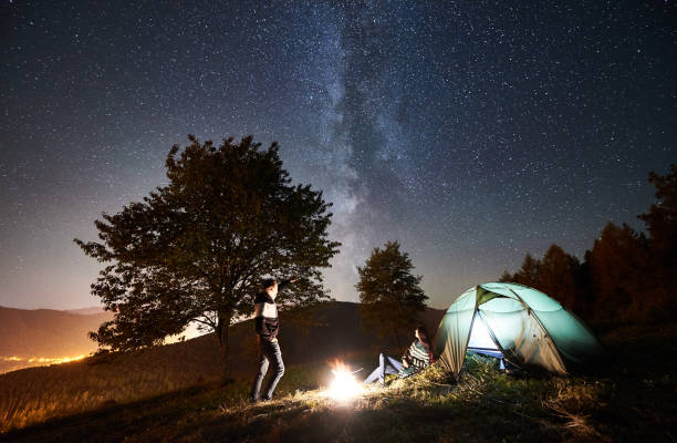 istock Couple tourists resting at night camping under stars 1133634227