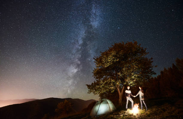 istock Couple tourists resting at night camping under stars 1133634242